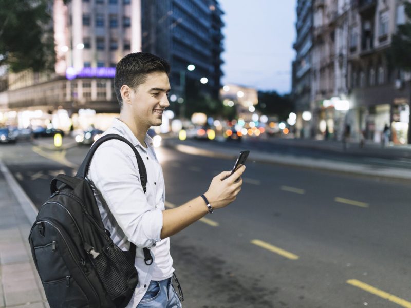 side-view-happy-man-looking-smartphone (1)